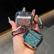 Glittery airpods case with carabiner held by a hand