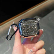 Hand holding a glittery black case with a carabiner