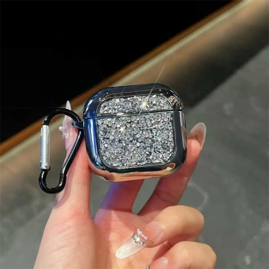 Hand holding a glittery silver case with a carabiner