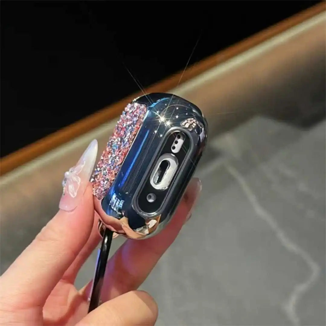 Airpods case with glittery design held by a hand