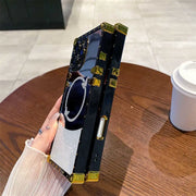 Phone case with jewelry display on a wooden table