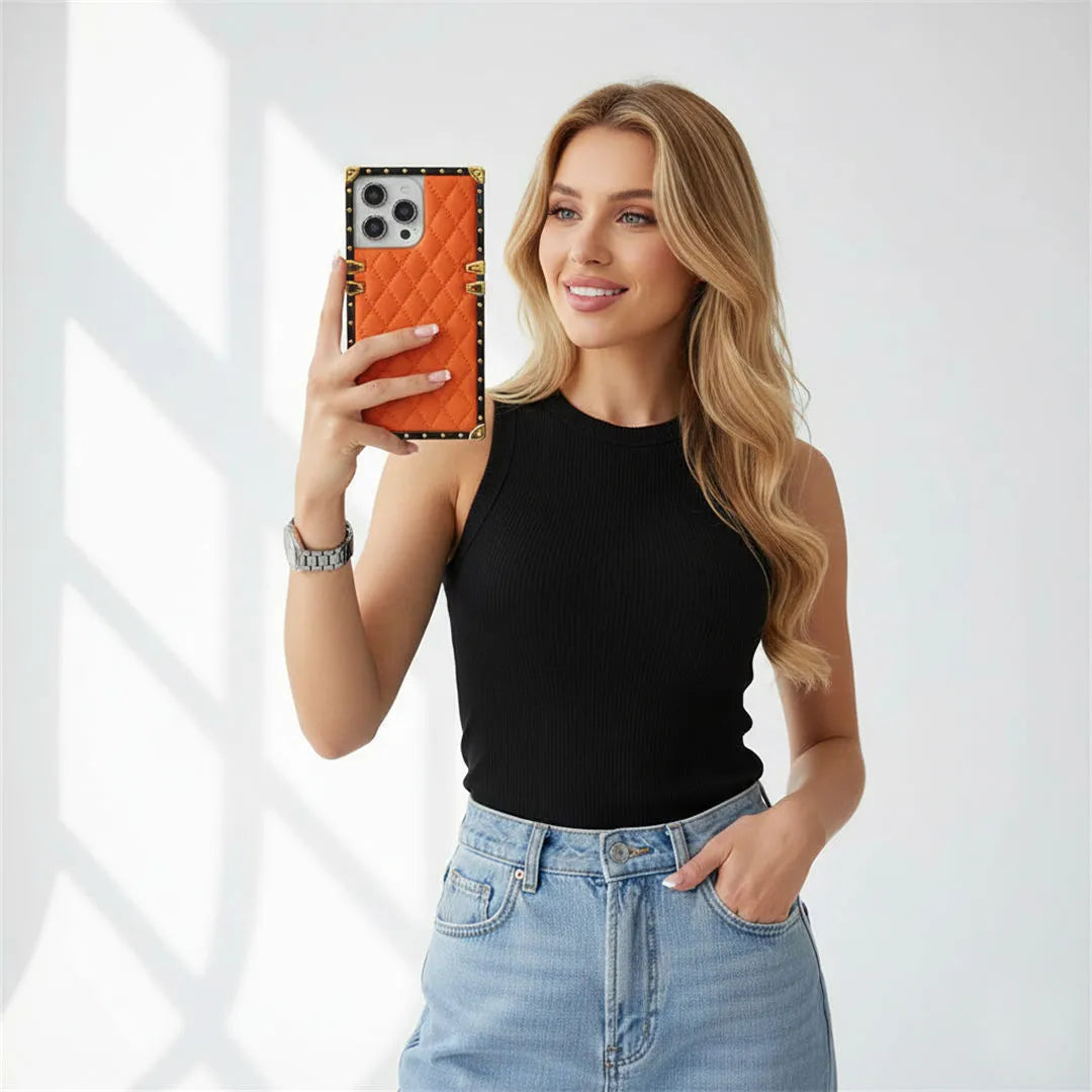 Woman holding a phone with an orange case against a white background