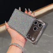 Hand holding a iPhone 17 Pro Max with a glittery case against a neutral background