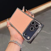 Phone case with diamond accents held by a hand against a neutral background