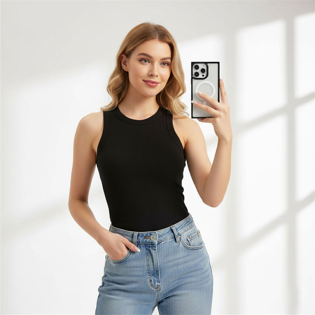 Woman holding a smartphone with a black case against a light background