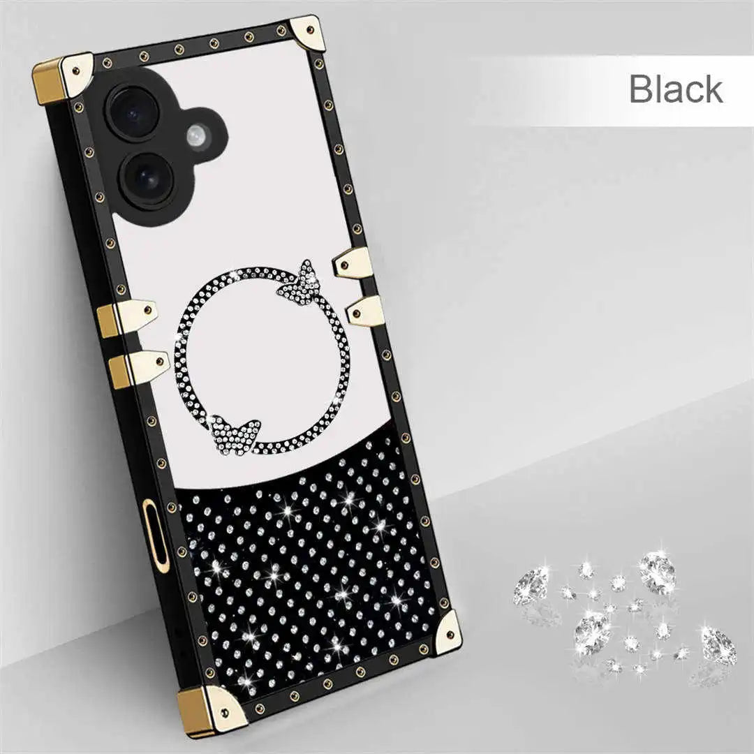 Black phone case with gold accents and white polka dots on a gray background