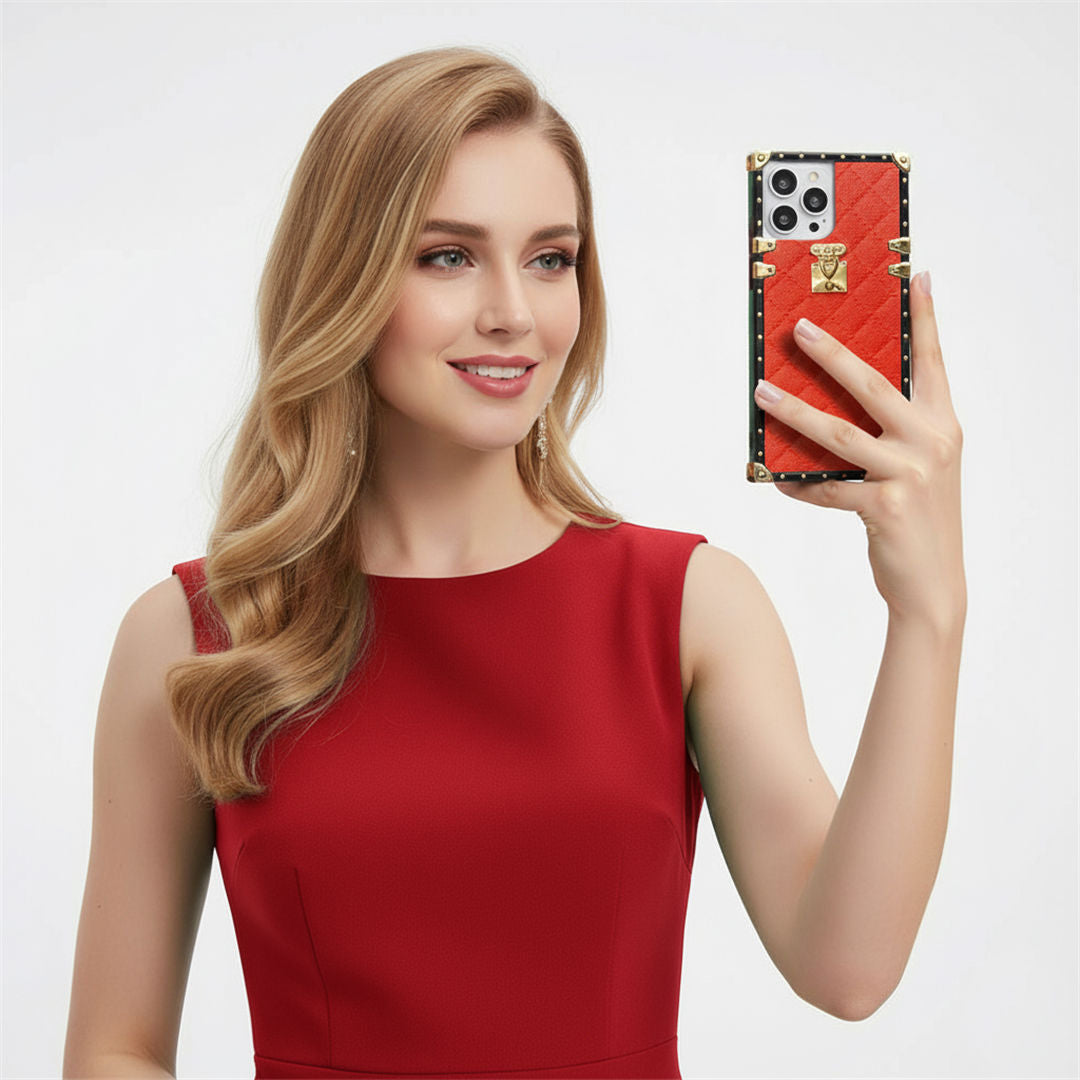 Woman in a red dress holding a phone with a red square phone case against a light gray background