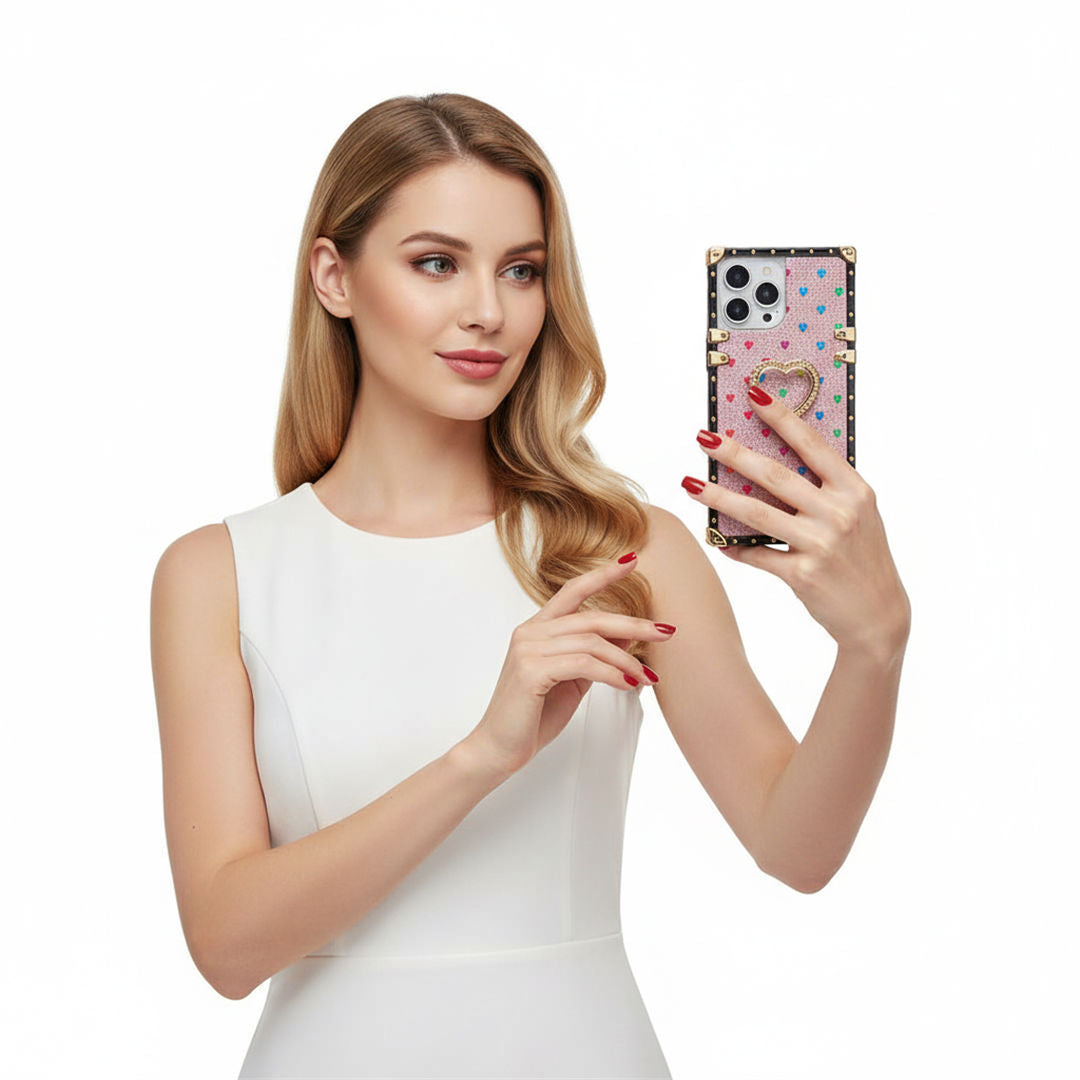 a woman holdiing a phone in pink glitter square iPhone case