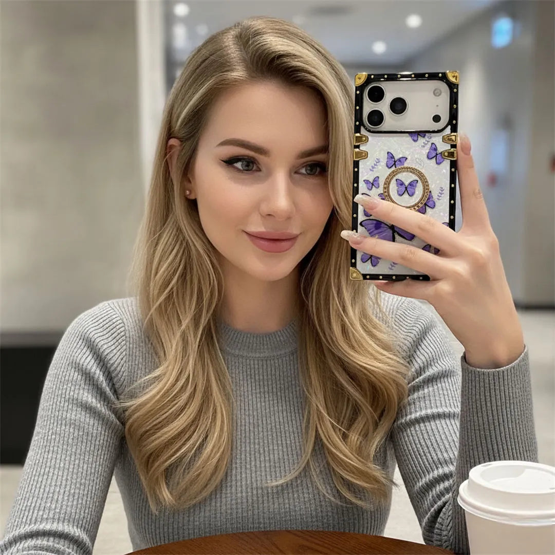 Woman holding a phone case with butterfly design in an indoor setting