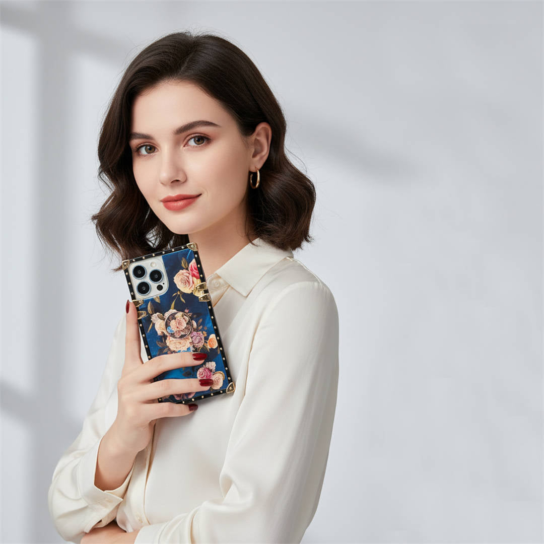 Woman holding a phone with a floral case against a light gray background