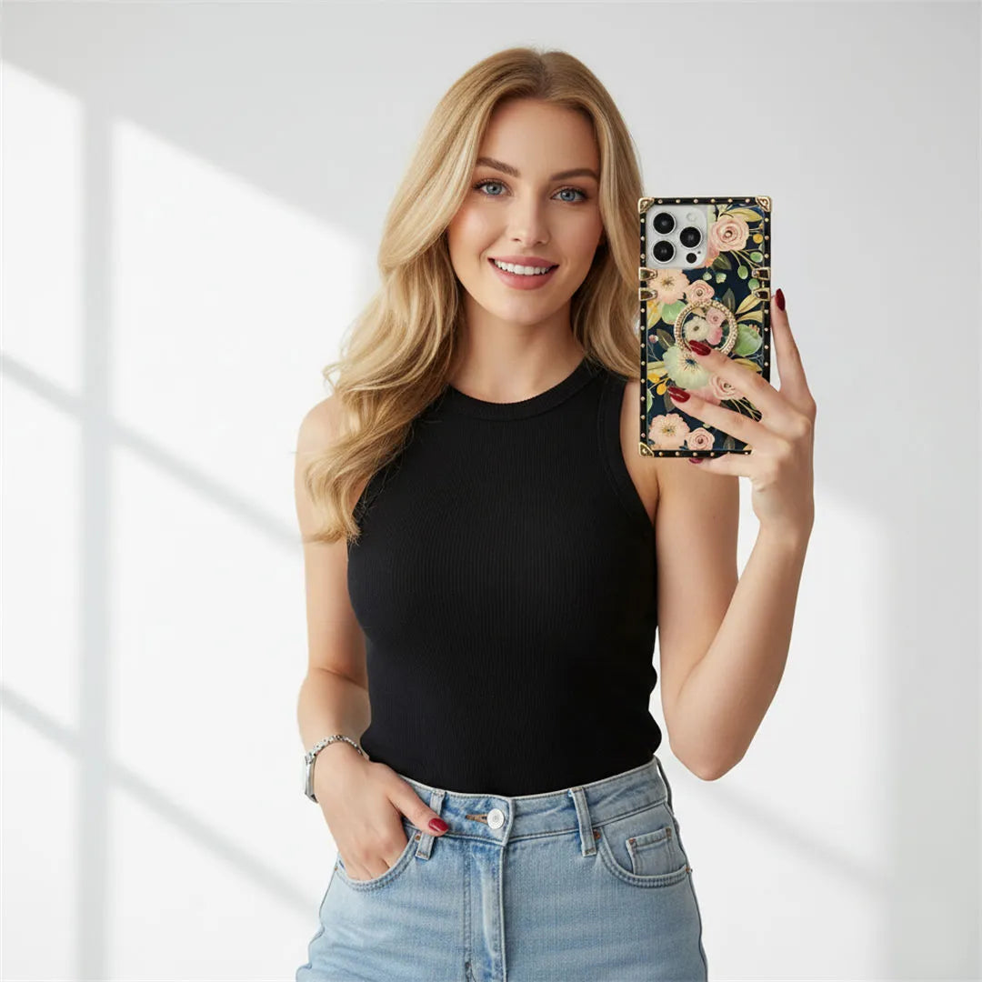 Woman holding a phone with a floral case against a white background
