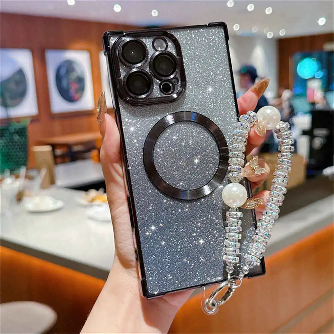 Phone case with glittery design and pearl strap held by a person in an indoor setting.