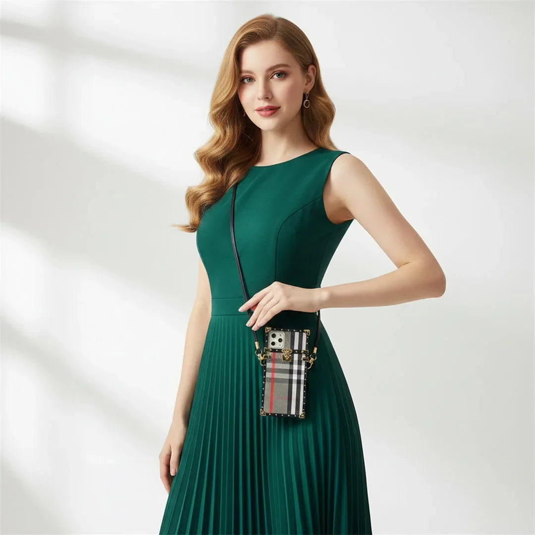 Woman in a green dress holding a handbag with a blurred background