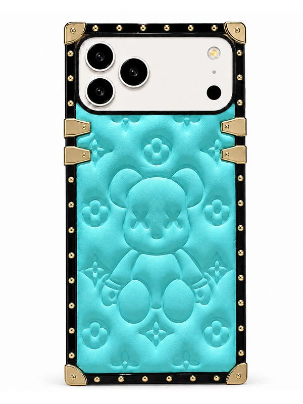 A protective phone case featuring a turquoise blue embossed teddy bear design with a black border and gold-tone hardware accents.
