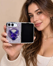 Woman holding an open iPhone Duo in the purple Duo Butterfly Gleam case