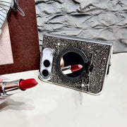 Black Duo Butterfly Gleam case propped horizontally with its mirror exposed for a lipstick check