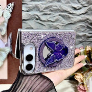 Purple Duo Butterfly Gleam case held horizontally with butterfly decoration over its mirror