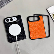 Two textured phone cases on a light gray surface, one black with a white MagSafe ring and charging cable inserted, and one orange with a black frame.