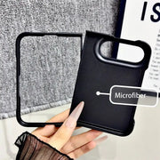A hand holds a black phone case with an outer frame, showing its microfiber back panel and camera cutout. A text label reads 'Microfiber'.