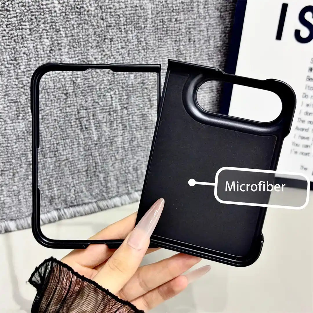 A hand holds a black phone case with an outer frame, showing its microfiber back panel and camera cutout. A text label reads 'Microfiber'.