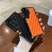 black and orange quilted Galaxy S26 Ultra phone cases in hand