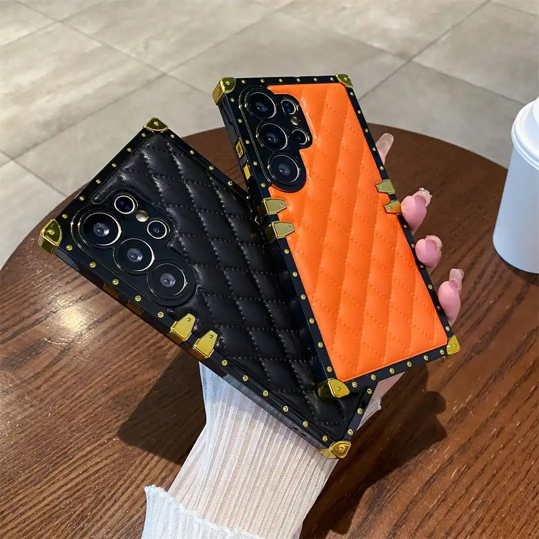 black and orange quilted Galaxy S26 Ultra phone cases in hand