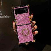 Hand holding a pink and gold phone case with intricate design