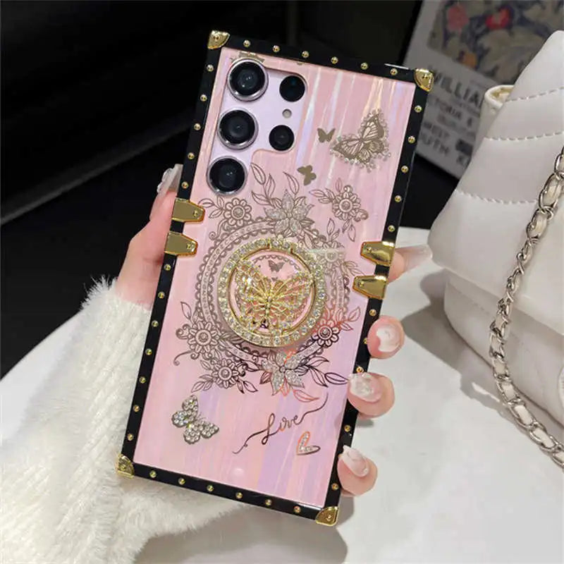 Pink Aurora Galaxy Trunk Samsung case held upright, showing butterfly details and gold-tone trim