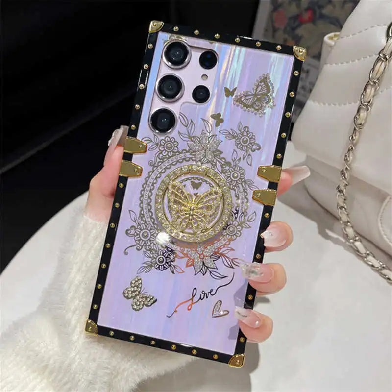 Hand holding the purple Aurora Galaxy Trunk Samsung case with butterfly ring stand