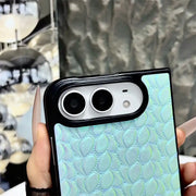 Close-up of the mint blue Prism Scale Duo case showing raised scale texture and black camera surround