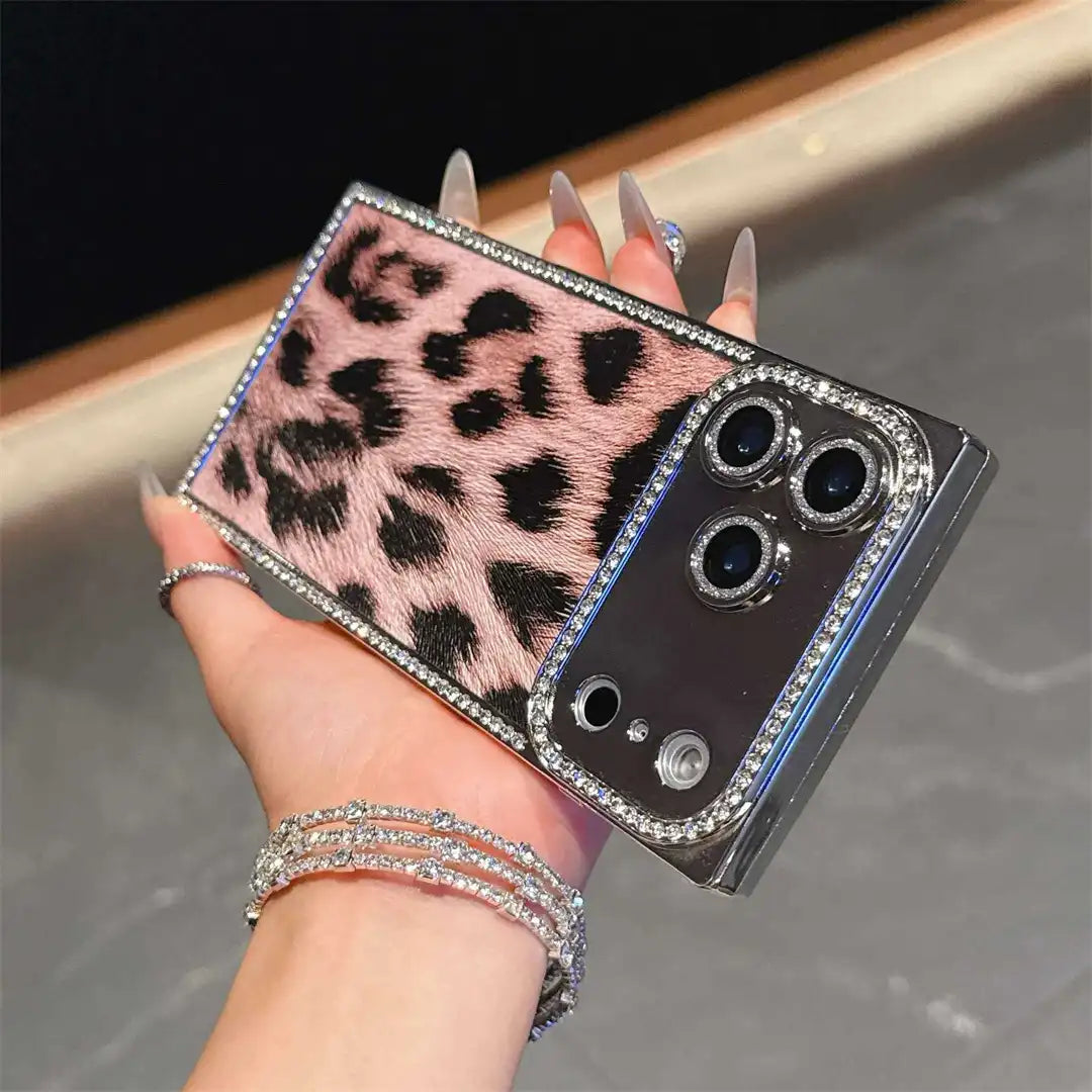 Pink Leopard Chrome Spark iPhone case held horizontally, showing leopard print and reflective camera panel