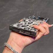 Bottom view of the gray Leopard Chrome Spark iPhone case showing charging-port and speaker cutouts