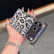 Gray Leopard Chrome Spark iPhone case held horizontally, showing leopard print and reflective camera panel
