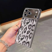Hand holding the gray Leopard Chrome Spark iPhone case with black leopard spots and rhinestone trim