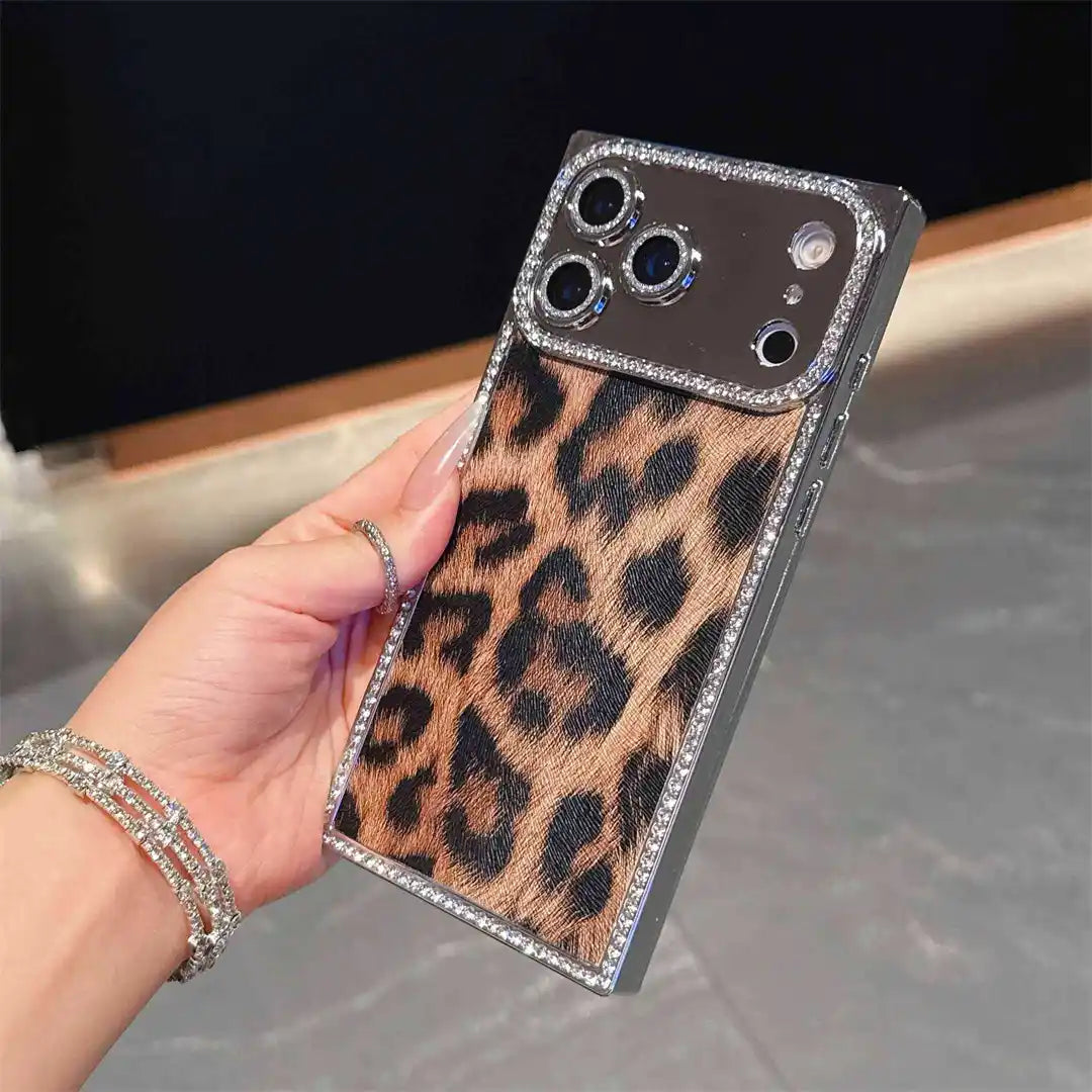 Hand holding the brown Leopard Chrome Spark iPhone case, showing leopard print and rhinestone trim