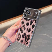 Hand holding the pink Leopard Chrome Spark iPhone case with black leopard spots and rhinestone trim