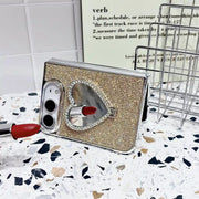Gold Crystal Heart Duo case propped horizontally with heart-shaped mirror reflecting a lipstick