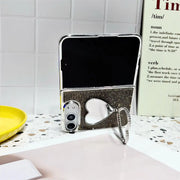 Black Crystal Heart Duo case holding an open iPhone Duo upright with the heart-shaped stand extended