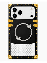 A luxury-style phone case designed for a Google Pixel, featuring a black and white color-blocked design with gold-tone rivets and corner protectors. The center of the black section displays a white diamond-encrusted circular motif with butterfly details.