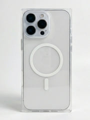 A clear MagSafe-compatible phone case shown on a white smartphone, featuring a white circular magnetic ring and a small white vertical tab on the back, set against a plain light gray background.