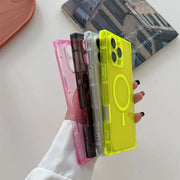 A hand holds a stack of four translucent phone cases in pink, black, clear, and bright yellow-green, with the yellow-green case in front showing a circular MagSafe-style ring cutout.