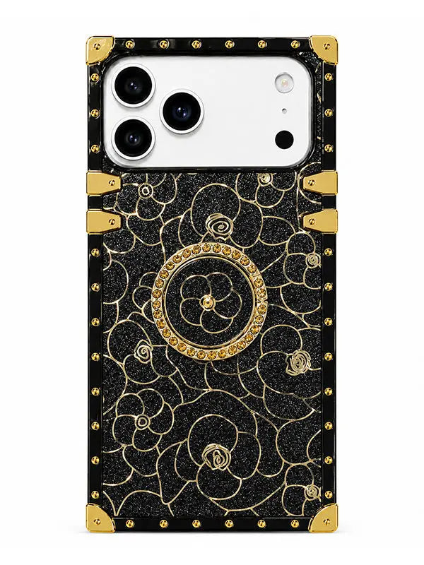 A protective phone case with a black textured background, gold floral patterns, and gold corner accents, shown on a white phone against a plain white background.