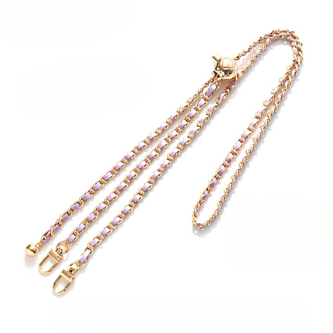 Gold chain with purple beads on a white background