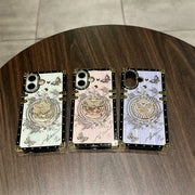 White, pink and purple Aurora Butterfly Trunk iPhone cases arranged on a round wooden table
