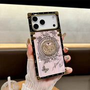 Hand holding the pink Aurora Butterfly Trunk iPhone case, showing butterfly details and gold-tone corners