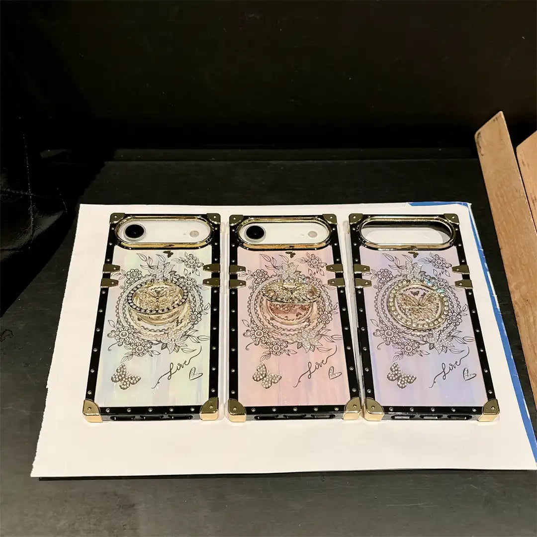 White, pink and purple Aurora Butterfly Trunk iPhone cases displayed side by side