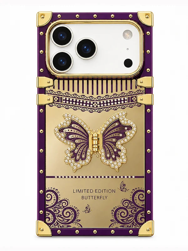 A luxury phone case designed like a gold and purple suitcase, featuring a 3D butterfly embellished with rhinestones, gold corner protectors, and the text 'LIMITED EDITION BUTTERFLY' on a white background.