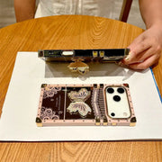 Phone case with butterfly design on a wooden table