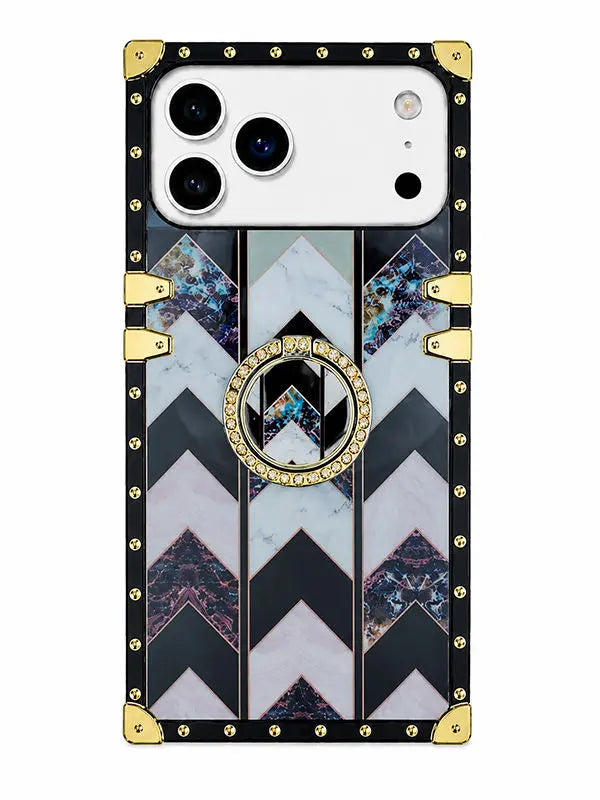 A luxury-style phone case with a black border, gold-tone studs and corner protectors, and a central chevron pattern featuring black, white, and blue-gray marble textures. A circular gold ring with a central 'W' logo is positioned on the back.