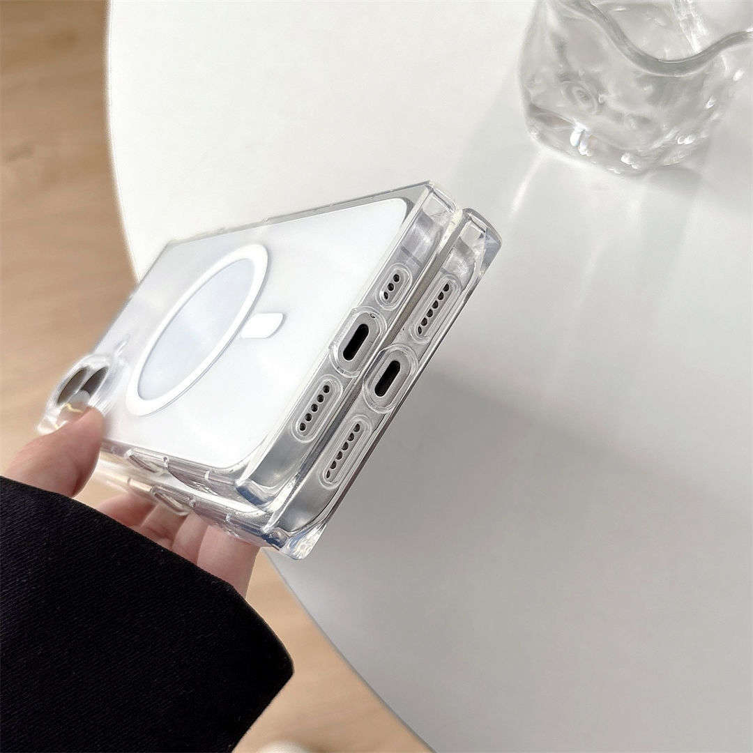 Clear phone case held by a hand on a white surface